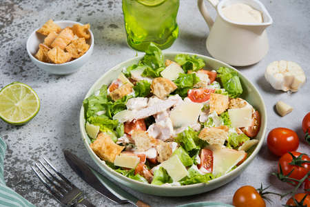 Italian Caesar salad with chicken breast on gray concrete backgroundの写真素材