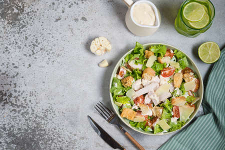 Italian Caesar salad with chicken breast on gray concrete backgroundの写真素材