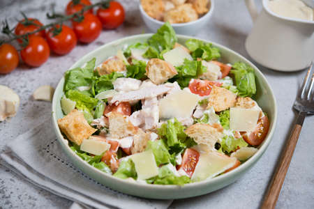 Italian Caesar salad with chicken breast on gray concrete backgroundの写真素材