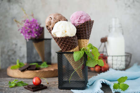 A variety of ice cream in waffle cones. Popsicle.