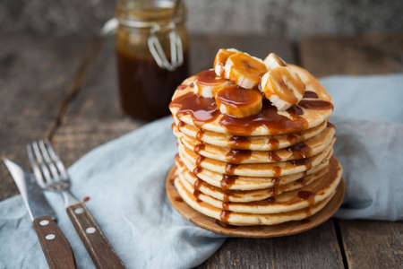 Traditional American pancake with soft caramel on a gray concrete background. Delicious Breakfast or brunch.の写真素材