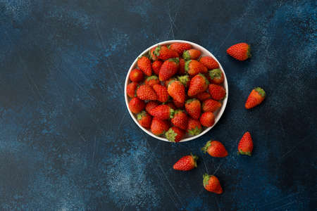 Garden fresh strawberries on concrete blue backgroundの写真素材