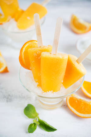 Frozen orange ice on a stick. Vegan dessert.