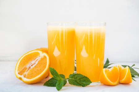Natural freshly squeezed orange juice in a glass glass on a white background.の写真素材