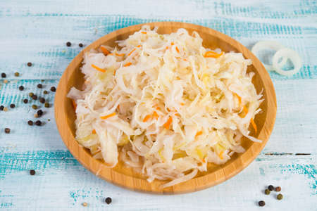 White fermented cabbage lies in a wooden plate in the center of the frame.の写真素材