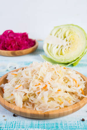 White fermented cabbage lies in a wooden plate in the center of the frame.の写真素材