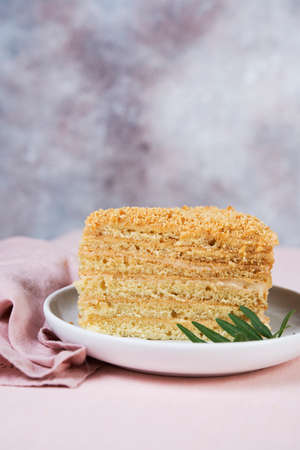 Delicious cake honey cake is on the table with flowers.の写真素材