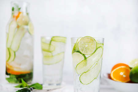 Homemade cold lemonade with lemon, lime, cucumber and mint on a white background.の写真素材