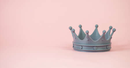 Plastic Royal crown isolated on pink background, banner, copy spaceの写真素材
