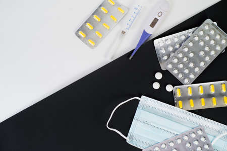 Medical mask, tablets and vitamins in a blister , thermometer, syringe, protection against...