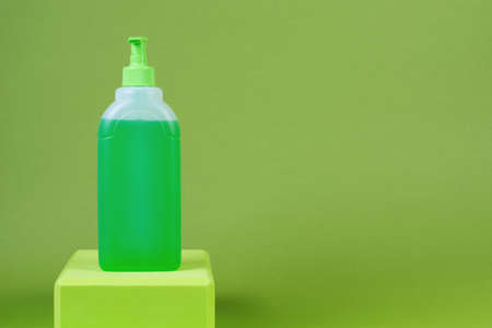 Wash and disinfect hands in a bottle on a green backgroundの写真素材