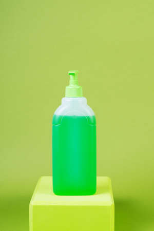 Hand washing and disinfection product in a bottle on a green background, protection against coronavirusの写真素材