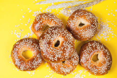 Creative layout of bagels on a bright yellow background, food concept