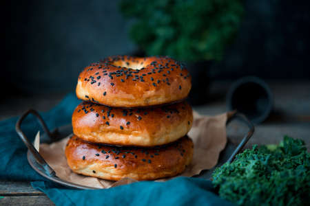 Homemade sesame bagels on an old wooden background, home bakeryの写真素材