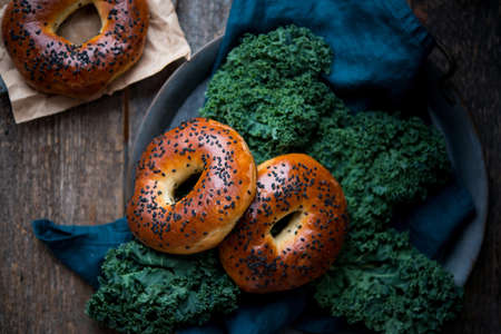 Homemade sesame bagels on an old wooden background, home bakeryの写真素材