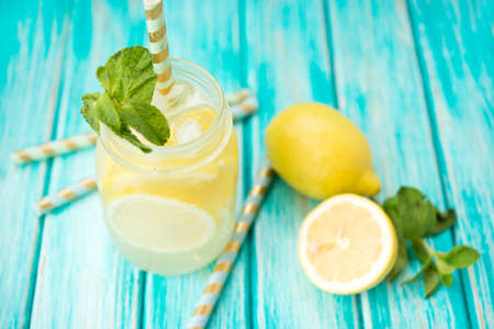 Homemade refreshing lemonade in a jar on a rustic backgroundの写真素材