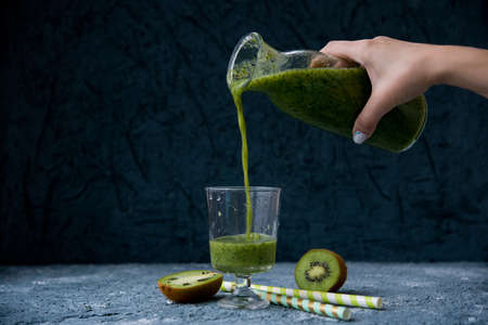 Vegetarian green spinach and kiwi smoothieの写真素材
