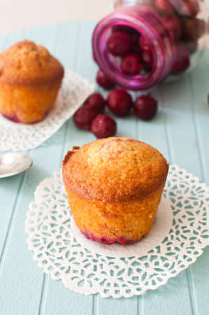 almond muffins with cherries on a blue background.の写真素材