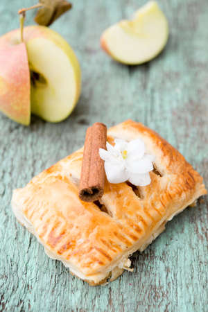 Homemade sweet pastries with Apple and cinnamon on a wooden Boardの写真素材