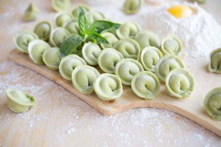 Raw green  dumplings on a wooden backgroundの写真素材