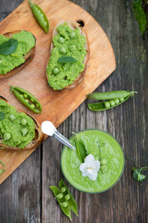 Homemade puree of green peas on a rustic backgroundの写真素材