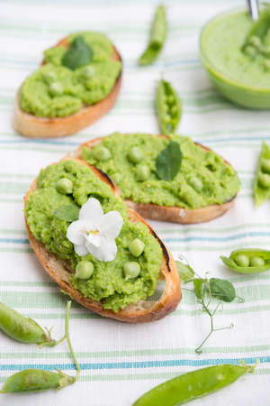 Homemade puree of green peas on a white rustic backgroundの写真素材
