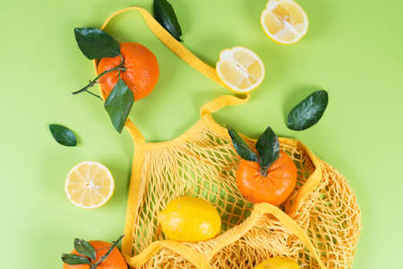 Juicy citrus fruits, lemons and tangerines on eco-bag, zero vast の写真素材