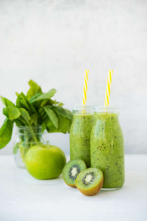 Fresh vegetarian smoothie drink in a glass bottle of green fruits and vegetables.の写真素材