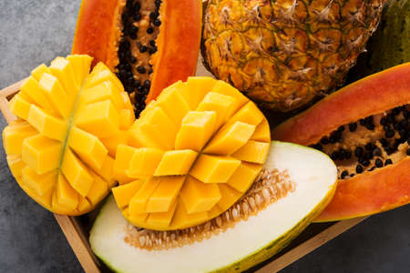 Lots of tropical fresh fruit, mango, melon, papaya, pineappleの写真素材