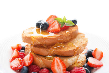 French wheat toast with fruit and honey isolated on a white background