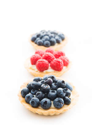 Mini tarts with berries isolated on a white background, close-upの写真素材