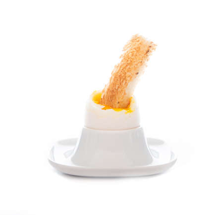 Boiled egg with toast for Breakfast on a white background, close-upの写真素材