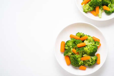 A plate of diet food, boiled vegetables, broccoli and carrots, fitness nutrition, selective focuseの写真素材