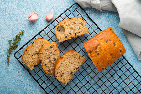Italian ciabatta bread with herbs, garlic and olives, top view