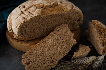 Homemade rye round bread on a dark background, selective focus