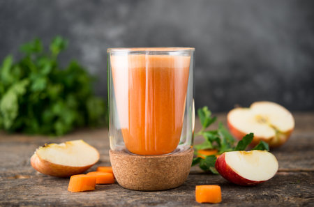 Fresh natural apple carrot juice in a glass glass, selective focusの写真素材