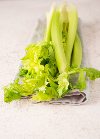 Fresh celery stalks on a white background, vegan clean food, selective focus