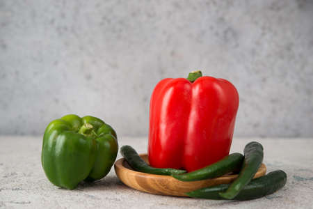 Fresh juicy bell peppers on a gray background, selective focus