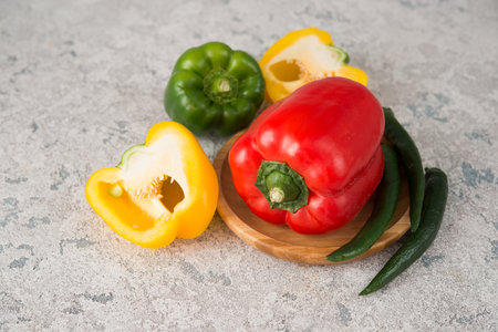 Fresh juicy bell peppers on a gray background, close up