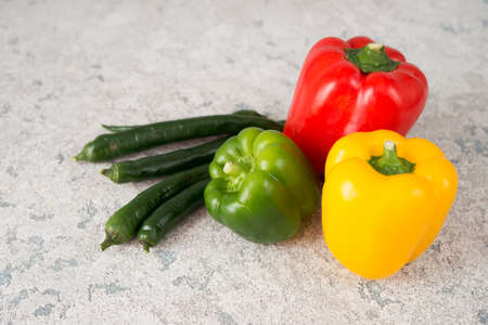 Fresh juicy bell peppers on a gray background, copy spaceの写真素材