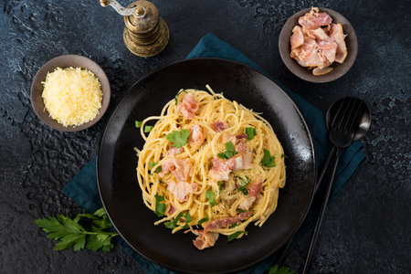 Pasta carbonara with bacon and parmesan on a plate, top viewの写真素材