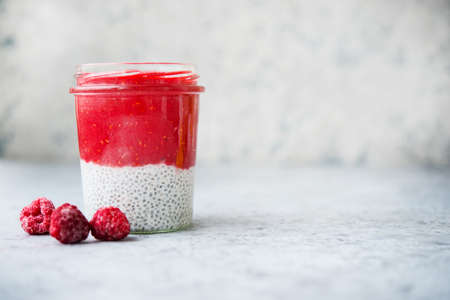 Vegetarian chia pudding with coconut milk and raspberry berry puree in a jar, healthy clean food, clean food, selective focus, copy spaceの写真素材