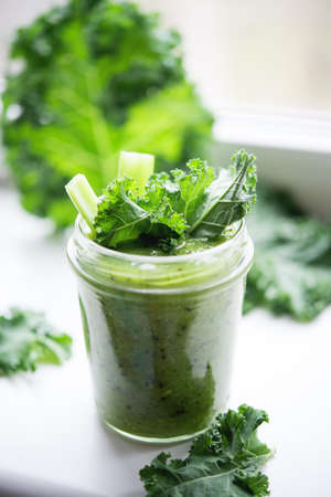 Green detox cocktail with cale salad, vegetarian healthy smoothie in a jar, selective focusの写真素材