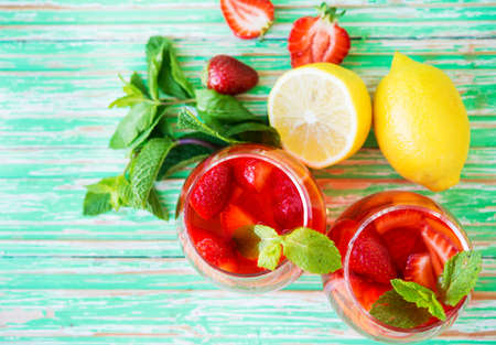 Homemade strawberry lemonade on a rustic background, a refreshing summer drink, top viewの写真素材