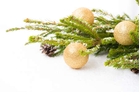 Christmas tree toys on a Christmas tree branch isolated on a white background, close-up, copy spaceの写真素材