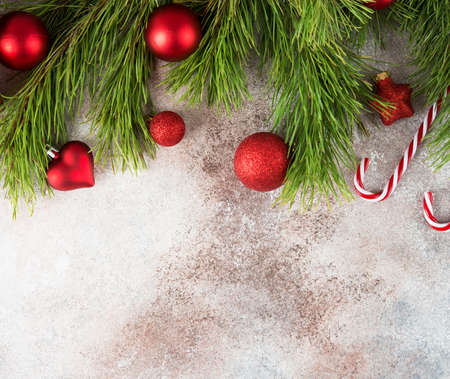 Christmas background with Christmas tree toy and Christmas tree branches, top view, copy of space