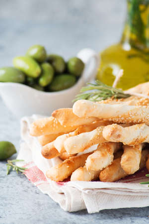 Italian grissini breadsticks with herbs and sesame seeds, selective focus, close-up