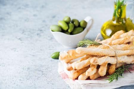 Italian grissini breadsticks with herbs and sesame seeds, selective focus, copy spaceの写真素材