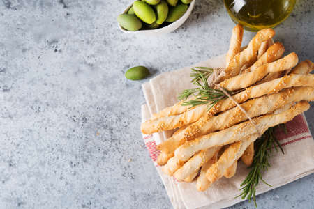 Italian grissini breadsticks with herbs and sesame seeds, copy space, top viewの写真素材