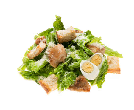 Caesar salad with chicken, croutons and parmesan isolated on a white background, close-upの写真素材